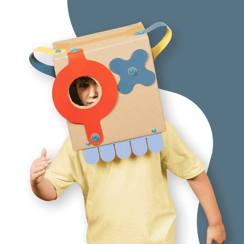 Child wearing cardboard creation made using Makedo Deco-Props Sparkies