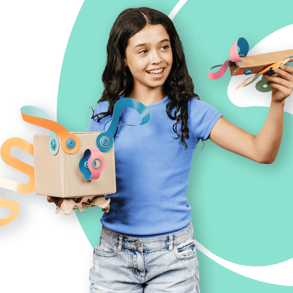 Girl holding a cardboard creation with colorful Makedo Deco-Props Twisties against a teal background