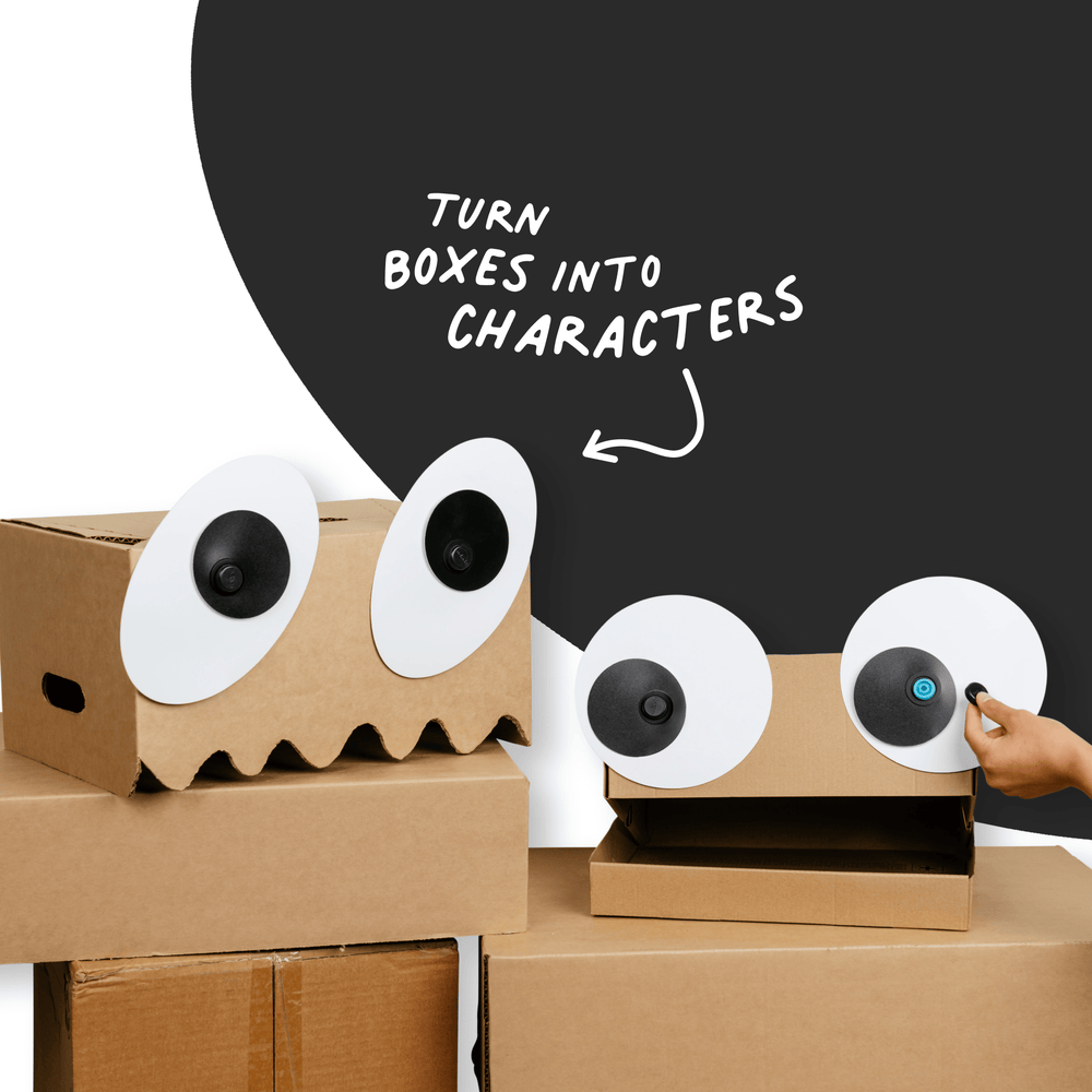 Cardboard boxes with Makedo Deco-Props Googlies eyes and a hand adding more eyes, with text 'Turn boxes into characters'.
