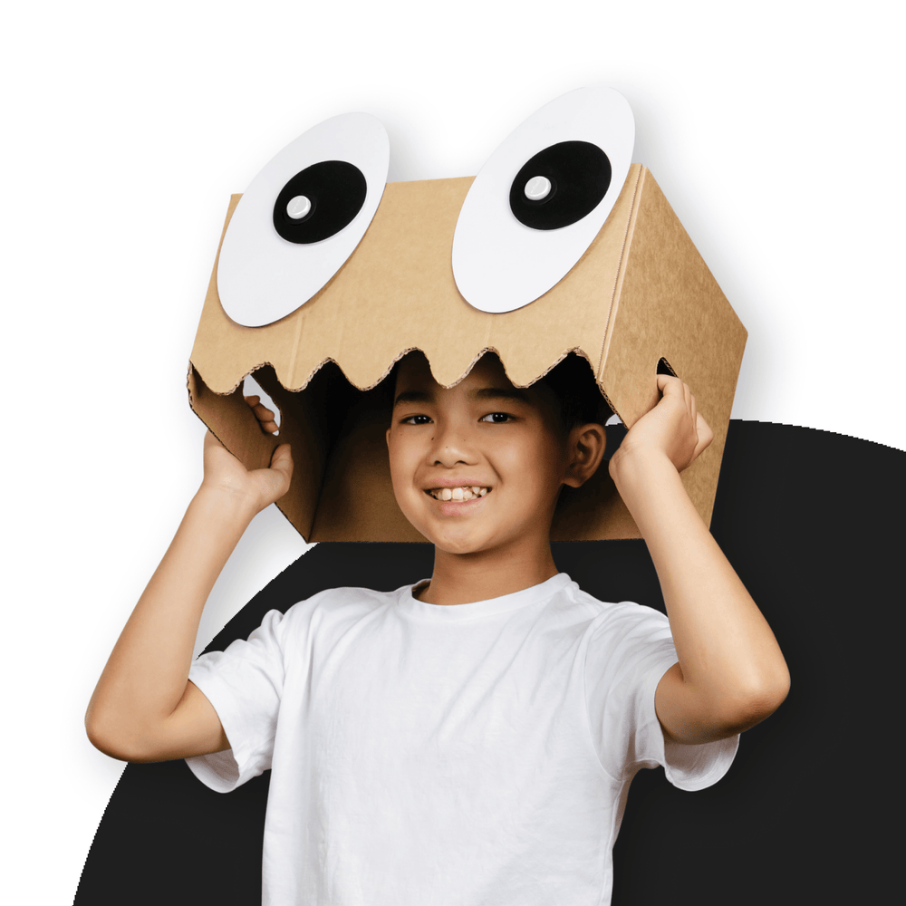 Child wearing a cardboard box costume with Makedo Deco-Props googly eyes attached